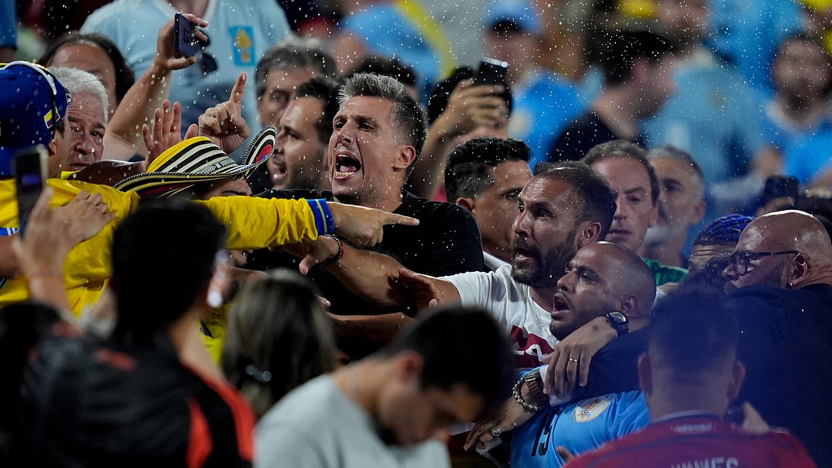 (AP Photo/Julia Nikhinson) : Uruguay's players argue with fans at the end of a Copa America semifinal soccer match against Colombia in Charlotte, N.C., Wednesday, July 10, 2024. 
